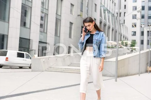 Girl standing outdoors and chatting Stock Photos