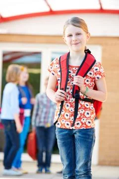 Girl Standing Outside School With Rucksack Stock Photos