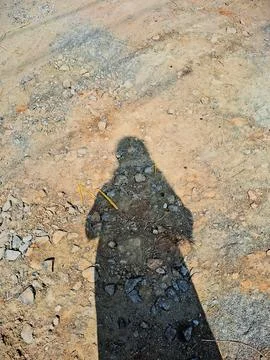 Girl standing shadow with sand background Stock Photos