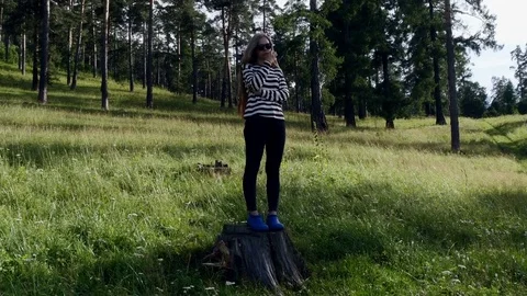 Girl is standing on the stump Stock-Footage 80220067