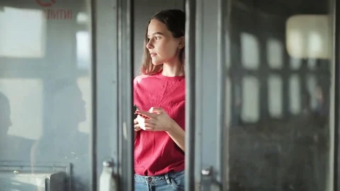 Girl standing in train and using smartphone Stock Footage 78884020