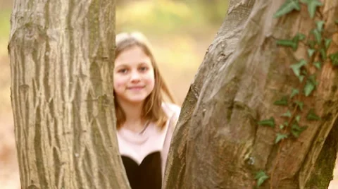 Girl standing by the tree and waving Stock Footage 59554428