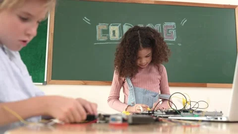 Girl standing while fixing electronic board by using screwdriver. Pedagogy. Stock Footage 270277844
