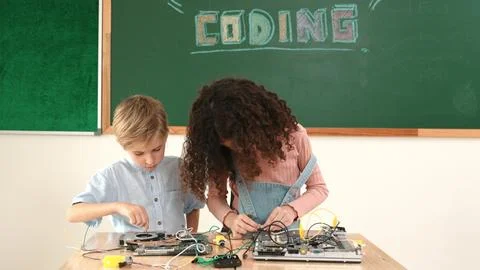Girl standing while fixing electronic board by using screwdriver. Pedagogy. Stock-Fotos