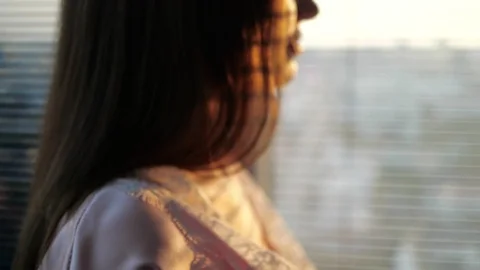 The girl is standing by the window in the apartment Stock Footage 101049904