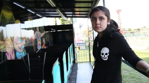 Girl stands by empty ride Stock Footage 154938757
