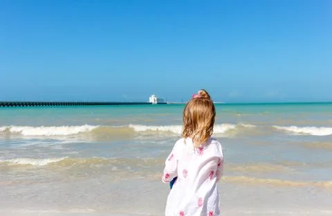 Girl staring  at the ocean Stock Photos