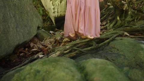 Girl stepping on rocks Video stock 288851113