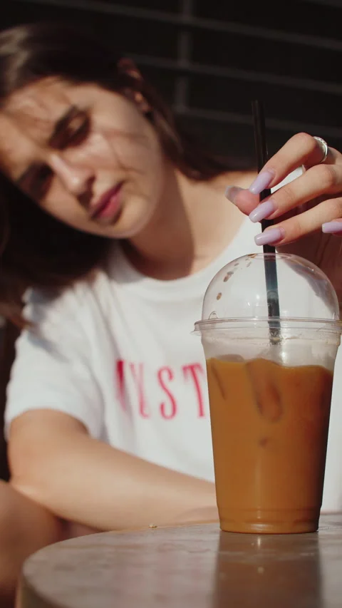 Iced coffee drink on glass jar with straw. Stock Photo by Civil