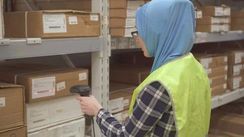 Girl store worker with barcode scanner of goods Stock-Fotos