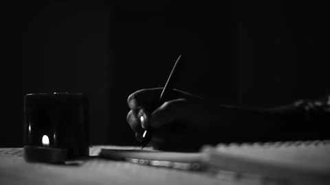A girl story Writing in dark room with candle light Stock Footage
