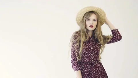 Girl in straw hat posing in studio. Slow motion. Stock Footage 114810908
