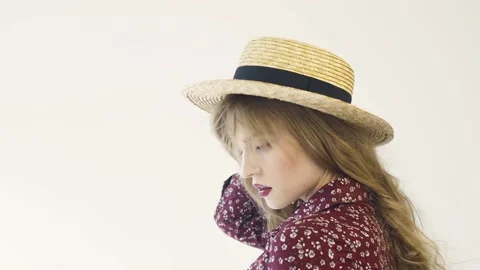 Girl in straw hat posing in studio. Slow motion. Stock Footage 114811093