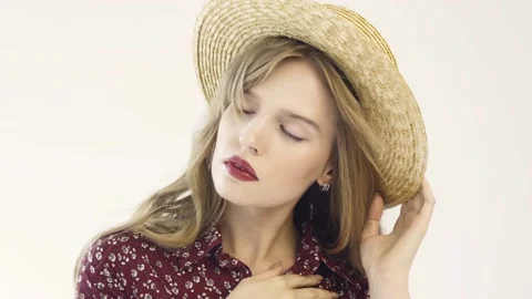 Girl in straw hat posing in studio. Slow motion. Stock Footage 114811466