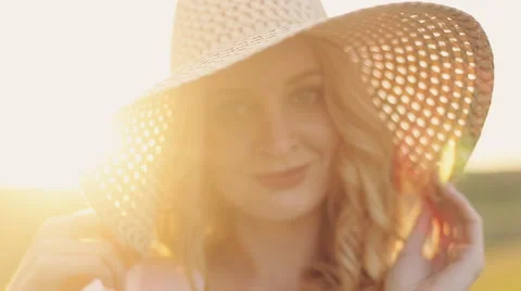Girl in a straw hat at sunset Stock Footage 66518904