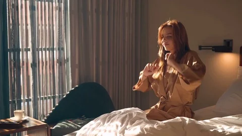 Girl streches out hands on bed in the morning Video stock 78802753