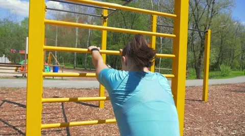 Girl is stretching on the ladder in the park. Stock Footage 63394445