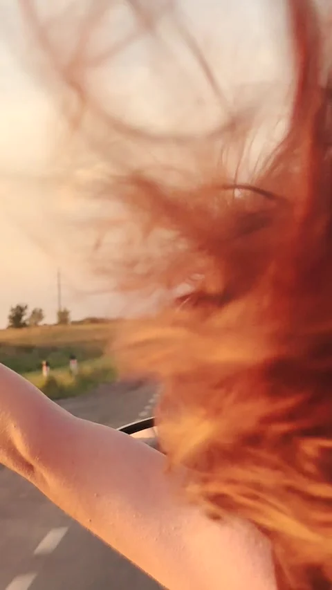 Girl stuck her hand out car window, glare sunlight fingers, happy road trip Stock Footage 278064053