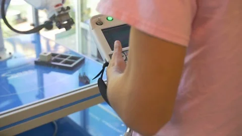Girl Student Controlling &amp; Programming Robotic Arm, Slow Motion Video stock 124345814