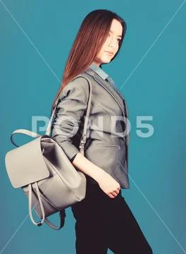 Girl student in formal clothes. Backpack fashion trend. Woman with leather Stock Photos