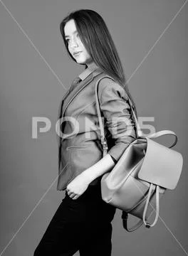 Girl student in formal clothes. Backpack fashion trend. Woman with leather Stock Photos