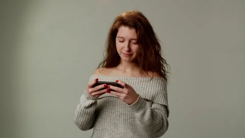 A girl student has fun, using a smartphone during a break between lessons Stock Footage 253258761