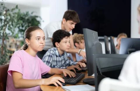 Girl student learning to work on computer in classroom Foto stock
