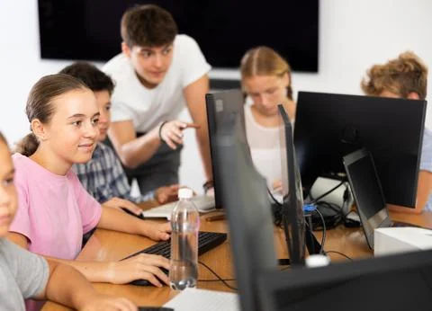 Girl student learning to work on computer in classroom Foto stock