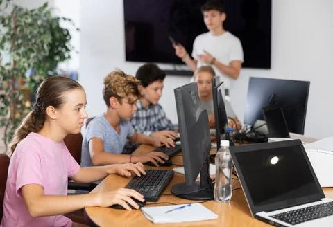 Girl student learning to work on computer in classroom Foto stock