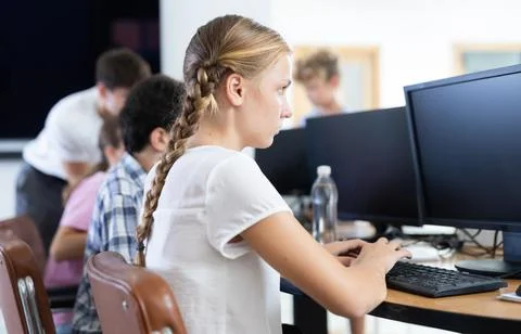 Girl student learning to work on computer in classroom 스톡 사진