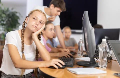 Girl student learning to work on computer in classroom Foto stock
