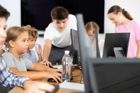 Girl student learning to work on computer in classroom Foto stock