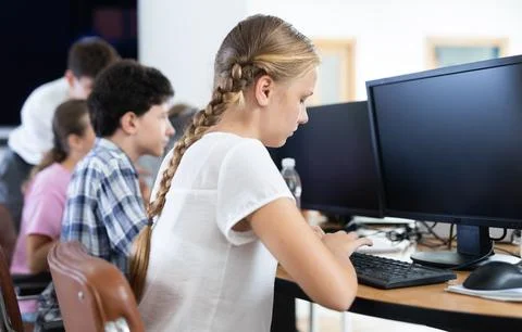 Girl student learning to work on computer in classroom 스톡 사진