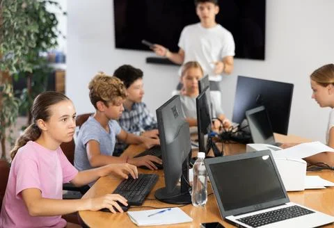 Girl student learning to work on computer in classroom Foto stock