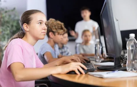 Girl student learning to work on computer in classroom 스톡 사진