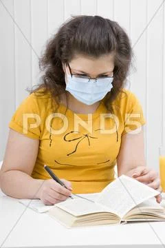 Girl student in a medical mask Stock Photos