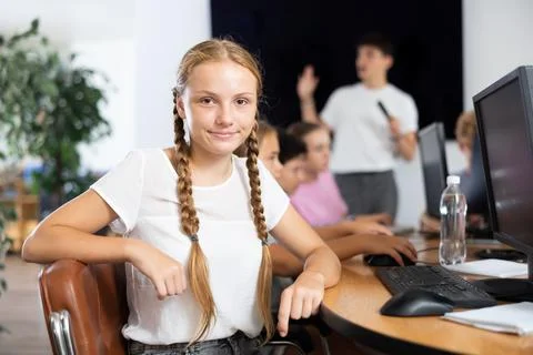 Girl student posing at computer in classroom Stock Photos