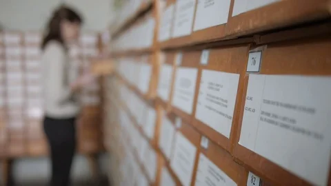 Girl student, reader in the library card catalog Stock Footage 71070776