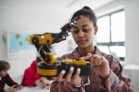 Girl student studying robotics while preparing for further education. Stock Photos
