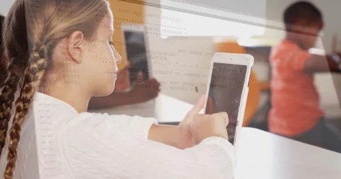 Girl student tapping tablet in classroom, displaying floating code overlay Video stock 307429342