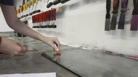 Girl student working in a workshop, preparing a paper for press machine Stock Footage 98623595