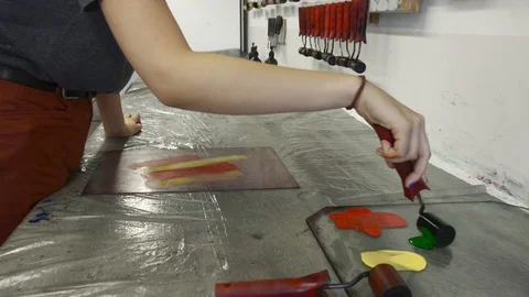 Girl student working in a workshop, preparing a paper for press machine Stock Footage 98623726