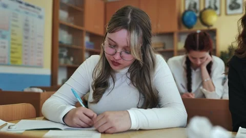 A girl student writes math formulas in a notebook. Stock Footage 258797682