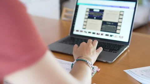 Girl studies and does homework at desk at home Stock Footage 285138309