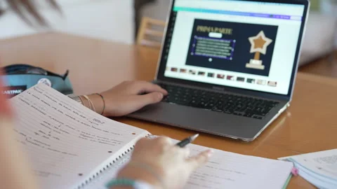 Girl studies and does homework at desk at home Stock Footage 285333641