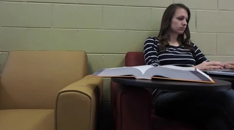 Girl studying in a library Stock Footage 46947784