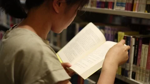 Girl studying in the library Stock Footage 279038157