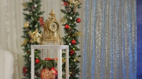 Girl in suit snow maiden sets Christmas clocks for the new year Video stock 82561953