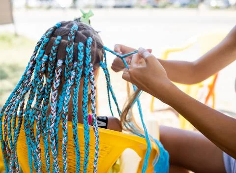 Hairdresser with Colored Afro Braids Weaves Ginger Dreadlocks