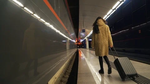 Girl with a suitcase on the platform Stock Footage 105815545
